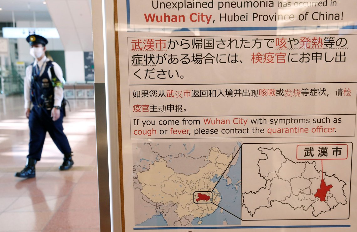 A policeman wearing a mask walks past a quarantine notice about the outbreak of coronavirus in Wuhan, China at an arrival hall of Haneda airport in Tokyo, Japan, January 20, 2020. REUTERS/Kim Kyung-Hoon A policeman wearing a mask walks past a quarantine notice about the outbreak of coronavirus in Wuhan, China at an arrival hall of Haneda airport in Tokyo, Japan, January 20, 2020. REUTERS/Kim Kyung-Hoon