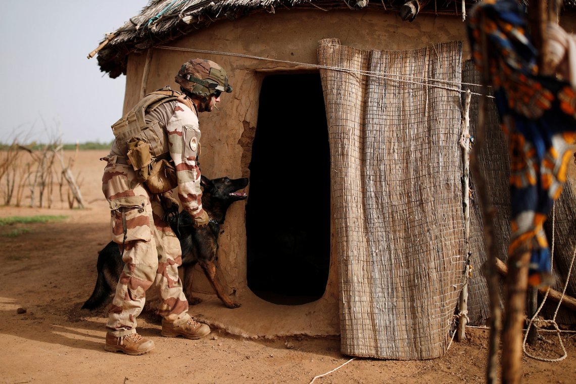 A French soldier of the "Belleface" Desert Tactical Group (GTD) uses a sniffer dog to check for explosives during an area control operation in the Gourma region as part of Operation Barkhane in Ndaki, Mali, July 29, 2019. REUTERS/Benoit Tessier SEARCH "TESSIER MALI" FOR THIS STORY. SEARCH "WIDER IMAGE" FOR ALL STORIES. A French soldier of the "Belleface" Desert Tactical Group (GTD) uses a sniffer dog to check for explosives during an area control operation in the Gourma region as part of Operation Barkhane in Ndaki, Mali, July 29, 2019. REUTERS/Benoit Tessier SEARCH "TESSIER MALI" FOR THIS STORY. SEARCH "WIDER IMAGE" FOR ALL STORIES.
