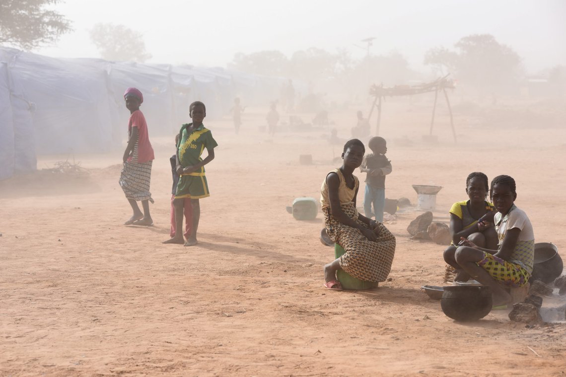 Displaced people, who fled from attacks of armed militants in Roffenega, are engulfed in dust as they sit at the camp built by the German Ngo HELP in Pissila, Burkina Faso January 24, 2020. Picture taken January 24, 2020. REUTERS/Anne Mimault Displaced people, who fled from attacks of armed militants in Roffenega, are engulfed in dust as they sit at the camp built by the German Ngo HELP in Pissila, Burkina Faso January 24, 2020. Picture taken January 24, 2020. REUTERS/Anne Mimault