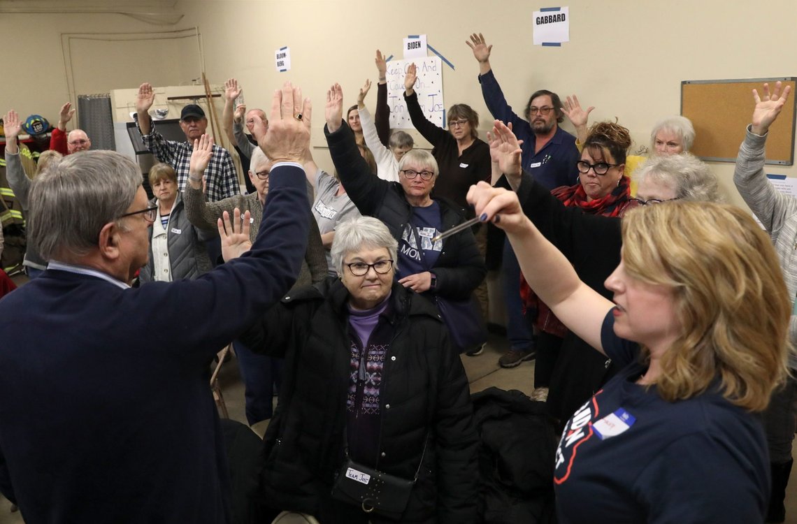 People put up their hands during a caucus at a fire station as Kellogg voters participate at the 2020 Democratic caucus in Kellogg, Iowa, U.S., February 3, 2020. REUTERS/Brenna Norman People put up their hands during a caucus at a fire station as Kellogg voters participate at the 2020 Democratic caucus in Kellogg, Iowa, U.S., February 3, 2020. REUTERS/Brenna Norman