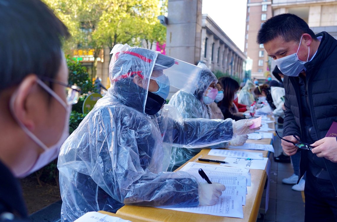 Community workers wearing makeshift protective suits help residents to register for coupons to purchase face masks at pharmacies, in Shanghai, China as the country is hit by an outbreak of the new coronavirus, February 2, 2020. Picture taken February 2, 2020. China Daily via REUTERS ATTENTION EDITORS - THIS IMAGE WAS PROVIDED BY A THIRD PARTY. CHINA OUT. Community workers wearing makeshift protective suits help residents to register for coupons to purchase face masks at pharmacies, in Shanghai, China as the country is hit by an outbreak of the new coronavirus, February 2, 2020. Picture taken February 2, 2020. China Daily via REUTERS ATTENTION EDITORS - THIS IMAGE WAS PROVIDED BY A THIRD PARTY. CHINA OUT.