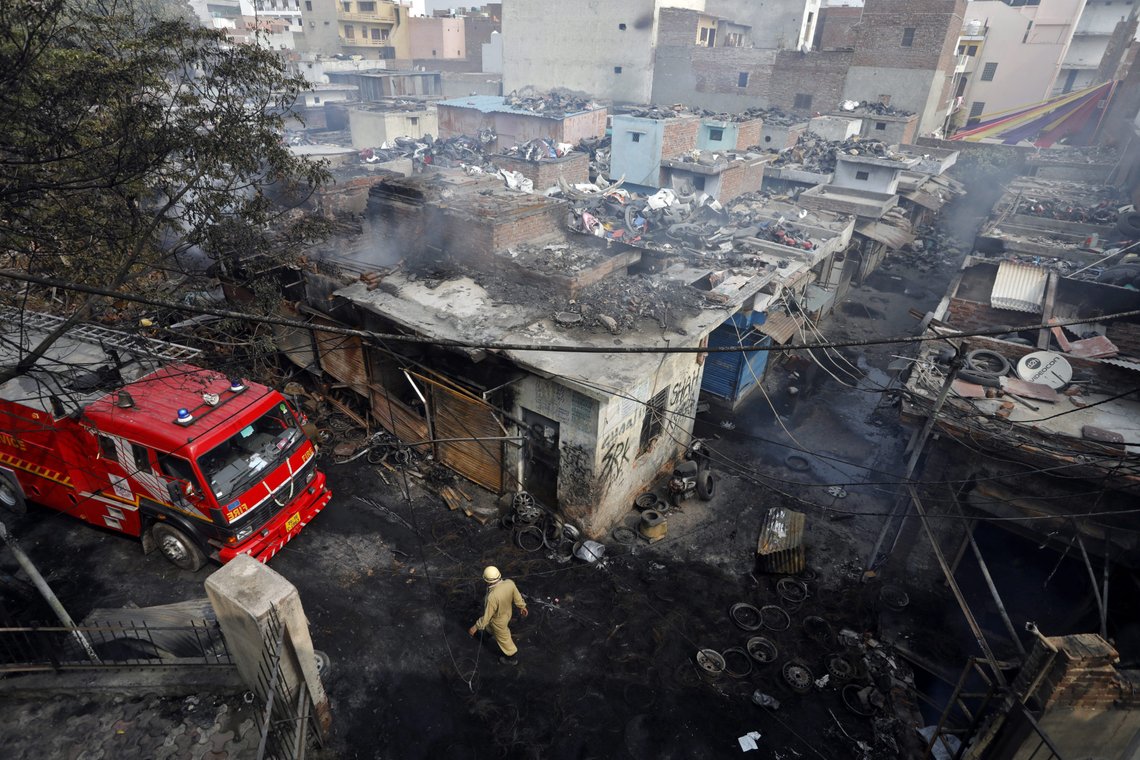 A firefighter walks past damaged shops at a tyre market after they were set on fire by a mob in a riot affected area after clashes erupted between people demonstrating for and against a new citizenship law in New Delhi, India, February 26, 2020. REUTERS/Adnan Abidi A firefighter walks past damaged shops at a tyre market after they were set on fire by a mob in a riot affected area after clashes erupted between people demonstrating for and against a new citizenship law in New Delhi, India, February 26, 2020. REUTERS/Adnan Abidi