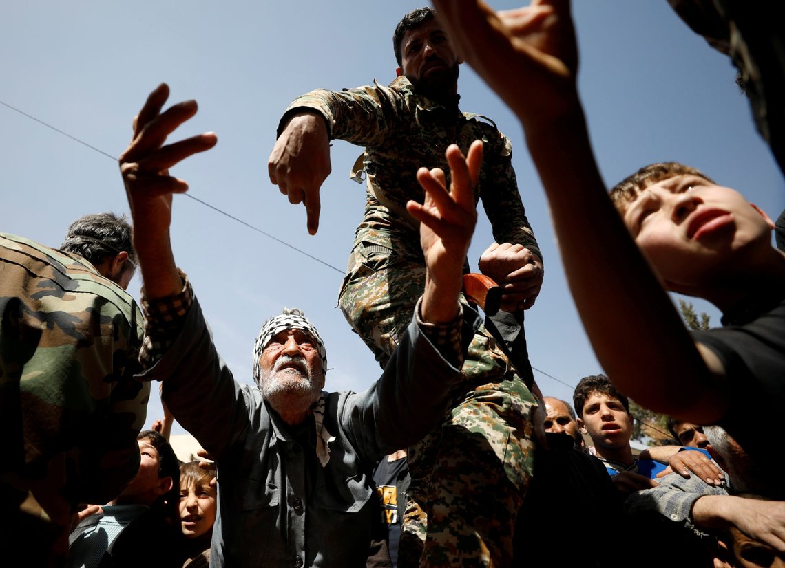 A man who fled eastern Ghouta gestures as he receives aid from Russian forces at a shelter in Adra, near Damascus, Syria, March 20, 2018. REUTERS/Omar Sanadiki TPX IMAGES OF THE DAY A man who fled eastern Ghouta gestures as he receives aid from Russian forces at a shelter in Adra, near Damascus, Syria, March 20, 2018. REUTERS/Omar Sanadiki TPX IMAGES OF THE DAY