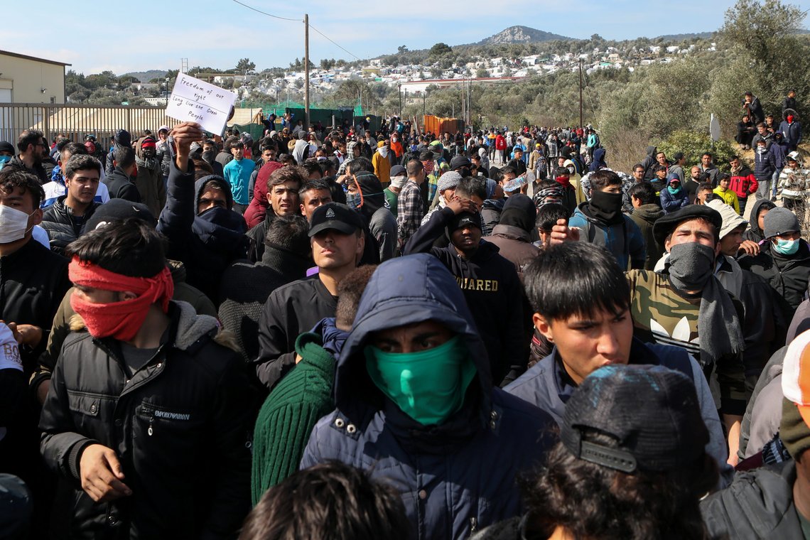 Migrants take part in a demonstration, following clashes with riot police near the Moria camp for refugees and migrants, on the island of Lesbos, Greece, March 2, 2020. REUTERS/Elias Marcou Migrants take part in a demonstration, following clashes with riot police near the Moria camp for refugees and migrants, on the island of Lesbos, Greece, March 2, 2020. REUTERS/Elias Marcou
