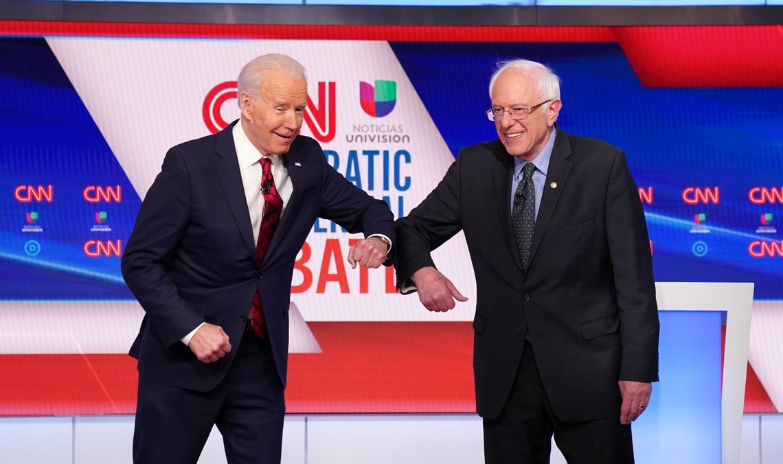 Democratic U.S. presidential candidates former Vice President Joe Biden and Senator Bernie Sanders do an elbow bump in place of a handshake as they greet other before the start of the 11th Democratic candidates debate of the 2020 U.S. presidential campaign, held in CNN's Washington studios without an audience because of the global coronavirus pandemic, in Washington, U.S. March 15, 2020. REUTERS/Kevin Lamarque TPX IMAGES OF THE DAY Democratic U.S. presidential candidates former Vice President Joe Biden and Senator Bernie Sanders do an elbow bump in place of a handshake as they greet other before the start of the 11th Democratic candidates debate of the 2020 U.S. presidential campaign, held in CNN's Washington studios without an audience because of the global coronavirus pandemic, in Washington, U.S. March 15, 2020. REUTERS/Kevin Lamarque TPX IMAGES OF THE DAY