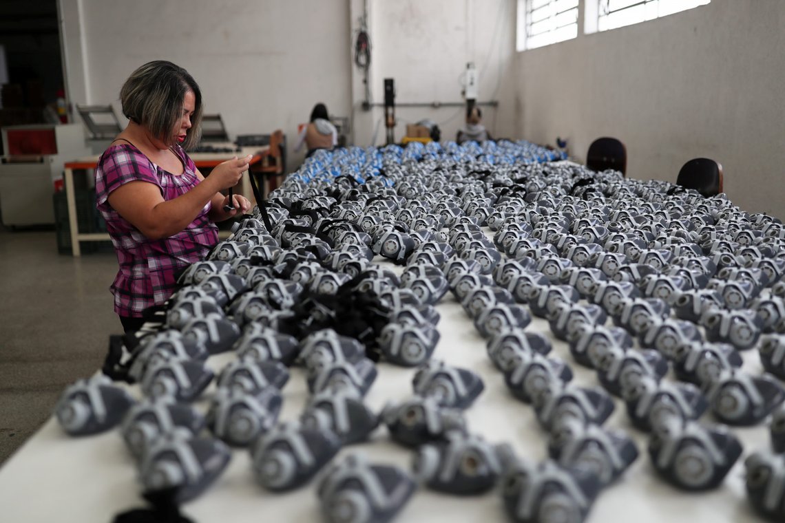 An employee puts stripes on protective face masks at Destra Brasil factory, which struggles with material shortage due to high demand after the coronavirus outbreak, in Sao Paulo, Brazil, March 2, 2020. Picture taken March 2, 2020. REUTERS/Amanda Perobelli An employee puts stripes on protective face masks at Destra Brasil factory, which struggles with material shortage due to high demand after the coronavirus outbreak, in Sao Paulo, Brazil, March 2, 2020. Picture taken March 2, 2020. REUTERS/Amanda Perobelli