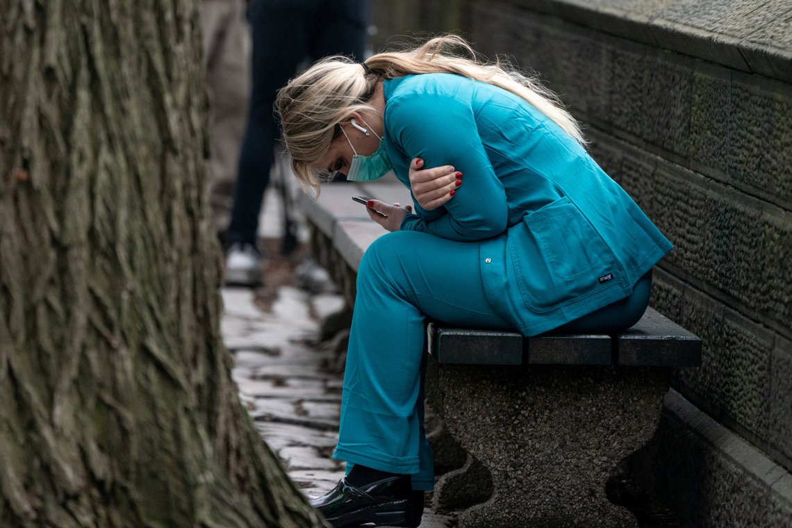 A healthcare worker sits on a bench near Central park in the Manhattan borough of New York City, U.S., March 30, 2020. REUTERS/Jeenah Moon TPX IMAGES OF THE DAY A healthcare worker sits on a bench near Central park in the Manhattan borough of New York City, U.S., March 30, 2020. REUTERS/Jeenah Moon TPX IMAGES OF THE DAY