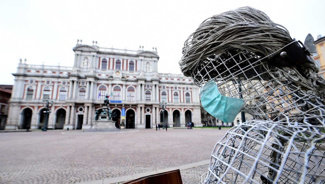 A face mask is attached to the sculpture at the Carlo Alberto square, after the government decree to close cinemas, schools and urge people to work from home and not stand closer than one metre to each other, in Turin, Italy, March 5, 2020. REUTERS/Massimo Pinca A face mask is attached to the sculpture at the Carlo Alberto square, after the government decree to close cinemas, schools and urge people to work from home and not stand closer than one metre to each other, in Turin, Italy, March 5, 2020. REUTERS/Massimo Pinca