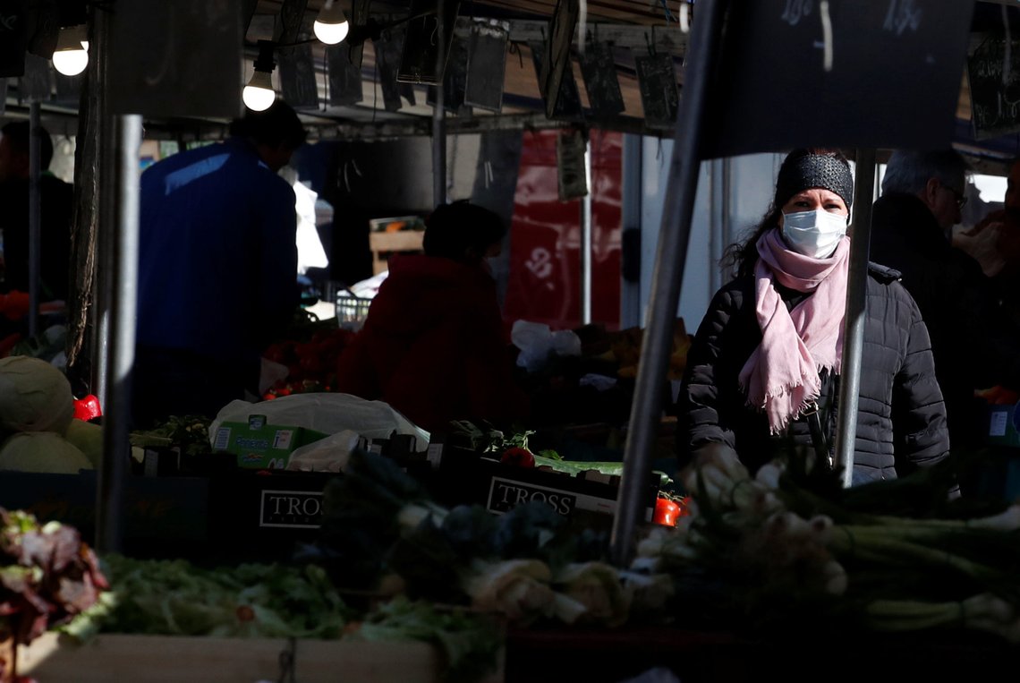 A woman, wearing a protective face mask, shops for fruit and vegetables at the Bastille Market in Paris as a lockdown is imposed to slow the rate of the coronavirus disease (COVID-19) in France, March 19, 2020. REUTERS/Gonzalo Fuentes A woman, wearing a protective face mask, shops for fruit and vegetables at the Bastille Market in Paris as a lockdown is imposed to slow the rate of the coronavirus disease (COVID-19) in France, March 19, 2020. REUTERS/Gonzalo Fuentes