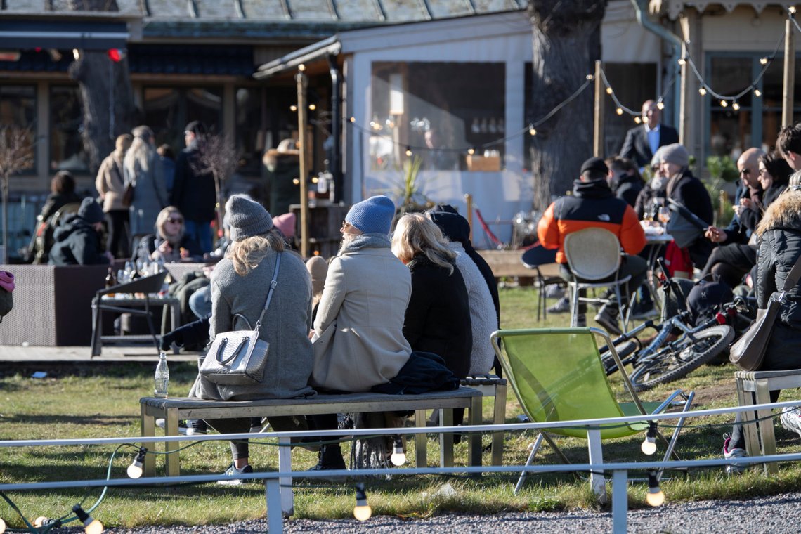 People enjoy the sunny weather at an outdoor restaurant at Djurgarden, as the coronavirus disease (COVID-19) continues to spread, in Stockholm, Sweden March 22, 2020. TT News Agency/Anders Wiklund via REUTERS ATTENTION EDITORS - THIS IMAGE WAS PROVIDED BY A THIRD PARTY. SWEDEN OUT. NO COMMERCIAL OR EDITORIAL SALES IN SWEDEN. People enjoy the sunny weather at an outdoor restaurant at Djurgarden, as the coronavirus disease (COVID-19) continues to spread, in Stockholm, Sweden March 22, 2020. TT News Agency/Anders Wiklund via REUTERS ATTENTION EDITORS - THIS IMAGE WAS PROVIDED BY A THIRD PARTY. SWEDEN OUT. NO COMMERCIAL OR EDITORIAL SALES IN SWEDEN.