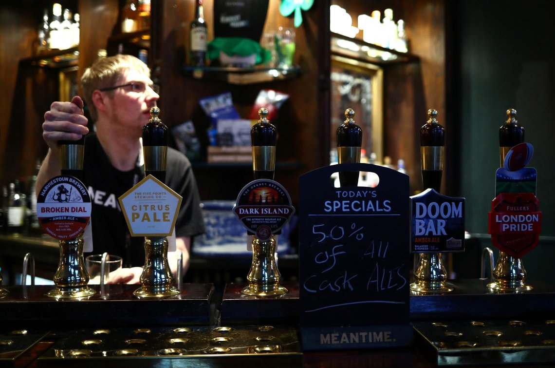 A barman pulls a pint after Britain's Prime Minister Boris Johnson annouced that cafes, pubs and restaurants across the country to close on Friday night to help stop the spread of the coronavirus disease (COVID-19). In Westminster, London, Britain March 20, 2020. REUTERS/Hannah McKay A barman pulls a pint after Britain's Prime Minister Boris Johnson annouced that cafes, pubs and restaurants across the country to close on Friday night to help stop the spread of the coronavirus disease (COVID-19). In Westminster, London, Britain March 20, 2020. REUTERS/Hannah McKay