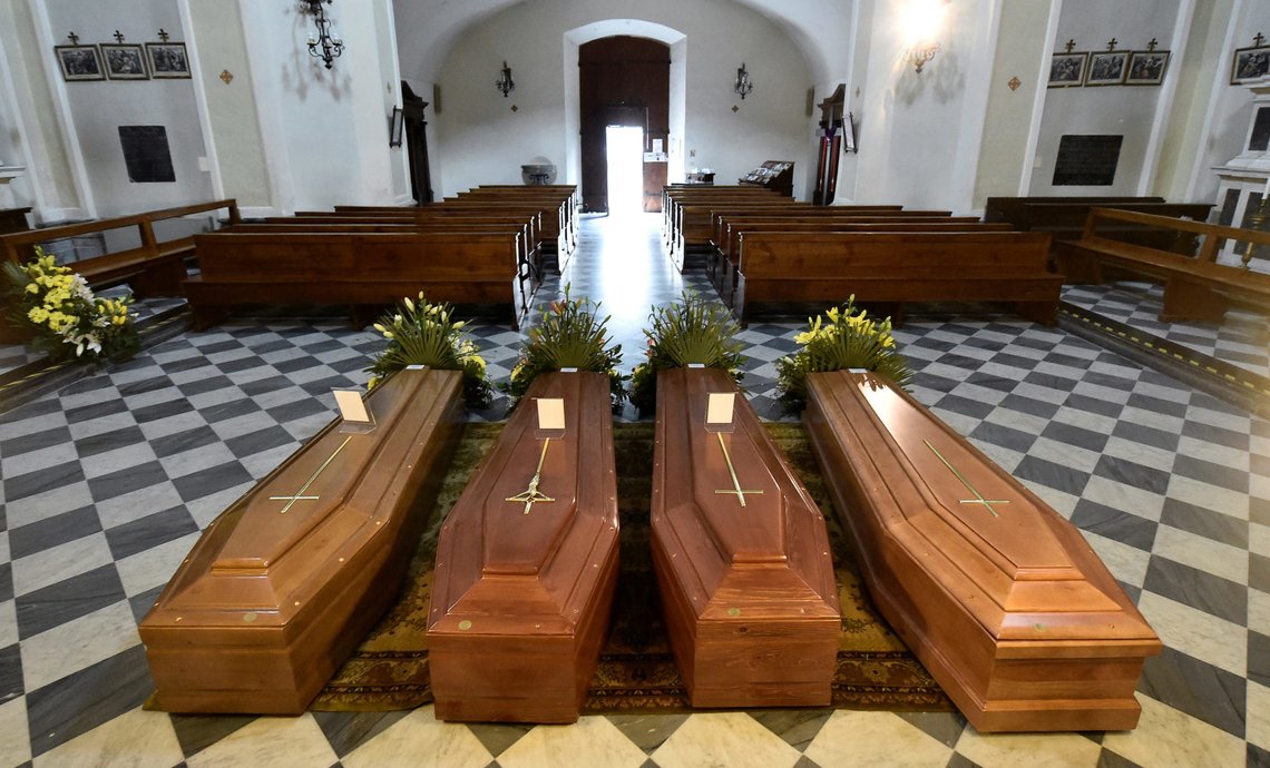 Coffins are seen inside a church in Serina near Bergamo, one of Italy's cities worst-hit by coronavirus disease (COVID-19), Italy March 22, 2020. REUTERS/Flavio Lo Scalzo Coffins are seen inside a church in Serina near Bergamo, one of Italy's cities worst-hit by coronavirus disease (COVID-19), Italy March 22, 2020. REUTERS/Flavio Lo Scalzo