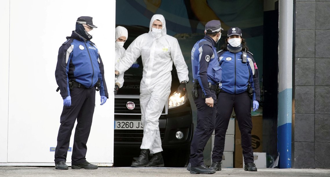 Local police stand next to a mortuary car, allegedly carrying the corpse of a person who died of coronavirus disease (COVID-19), at the entrance of an ice rink which will be used as a morgue, during the coronavirus disease (COVID-19) outbreak in Madrid, Spain, March 24, 2020. REUTERS/Juan Medina Local police stand next to a mortuary car, allegedly carrying the corpse of a person who died of coronavirus disease (COVID-19), at the entrance of an ice rink which will be used as a morgue, during the coronavirus disease (COVID-19) outbreak in Madrid, Spain, March 24, 2020. REUTERS/Juan Medina