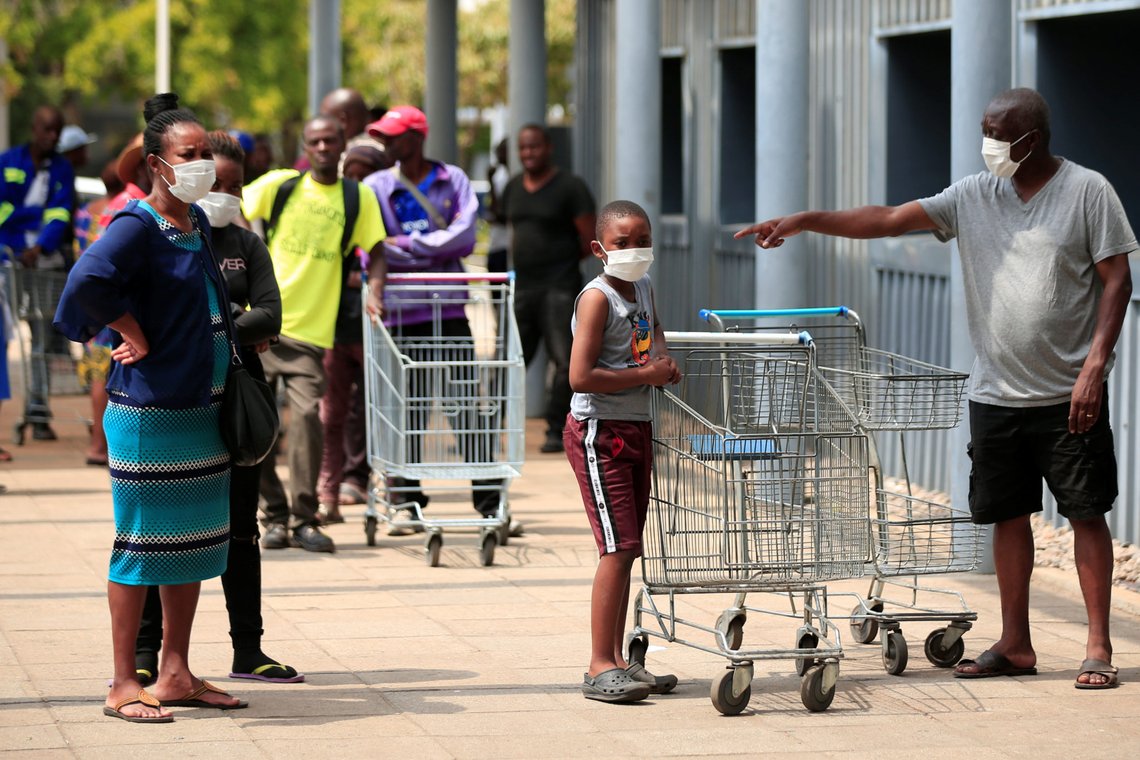 People queue to shop ahead of a nationwide 21-day lockdown called by the government to limit the spread of coronavirus disease (COVID-19) in Harare, Zimbabwe, March 28, 2020. REUTERS/Philimon Bulawayo People queue to shop ahead of a nationwide 21-day lockdown called by the government to limit the spread of coronavirus disease (COVID-19) in Harare, Zimbabwe, March 28, 2020. REUTERS/Philimon Bulawayo