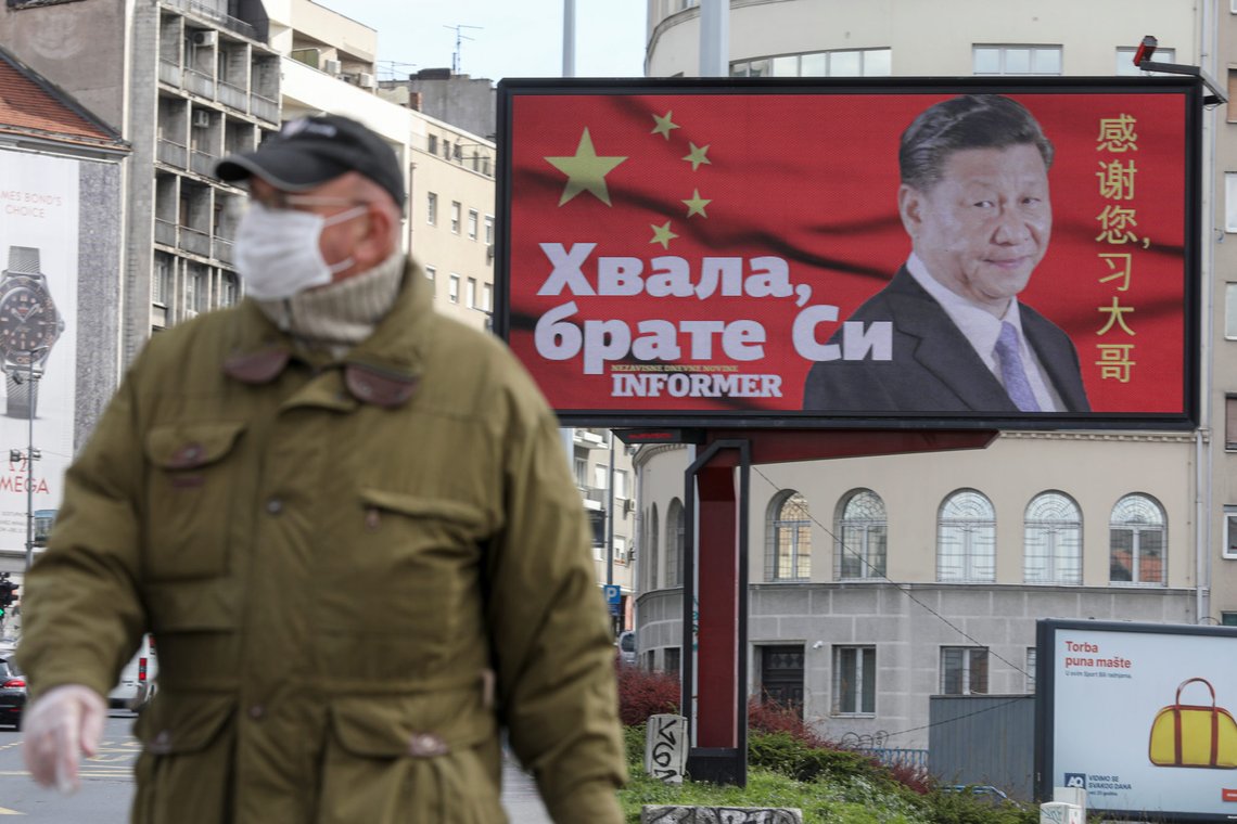 A man wearing a protective mask passes by a billboard depicting Chinese President Xi Jinping as the spread of the coronavirus disease (COVID-19) continues in Belgrade, Serbia, April 1, 2020. The text on the billboard reads "Thanks, brother Xi". Picture taken April 1, 2020. REUTERS/Djordje Kojadinovic A man wearing a protective mask passes by a billboard depicting Chinese President Xi Jinping as the spread of the coronavirus disease (COVID-19) continues in Belgrade, Serbia, April 1, 2020. The text on the billboard reads "Thanks, brother Xi". Picture taken April 1, 2020. REUTERS/Djordje Kojadinovic