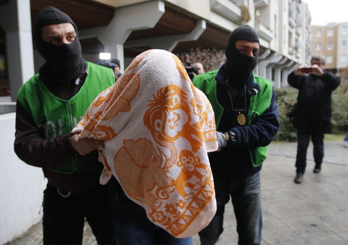 A suspect is detained by plain clothes police during a raid at a house in the Kreuzberg district of Berlin, Germany February 4, 2016. German police conducted raids in Berlin and other parts of northern Germany on Thursday in a search for four men suspected of links to Islamic State militants and possibly preparing an attack in Germany, police said. REUTERS/Fabrizio Bensch TPX IMAGES OF THE DAY A suspect is detained by plain clothes police during a raid at a house in the Kreuzberg district of Berlin, Germany February 4, 2016. German police conducted raids in Berlin and other parts of northern Germany on Thursday in a search for four men suspected of links to Islamic State militants and possibly preparing an attack in Germany, police said. REUTERS/Fabrizio Bensch TPX IMAGES OF THE DAY