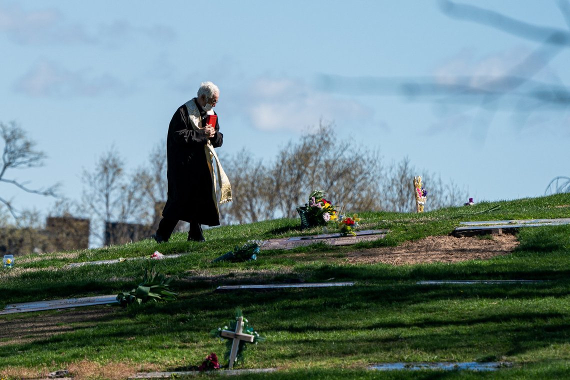 A pastor wearing a protective mask is seen at The Green-Wood Cemetery during the outbreak of the coronavirus disease (COVID-19) in the Brooklyn borough of New York City, New York, U.S., April 11, 2020. REUTERS/Jeenah Moon TPX IMAGES OF THE DAY A pastor wearing a protective mask is seen at The Green-Wood Cemetery during the outbreak of the coronavirus disease (COVID-19) in the Brooklyn borough of New York City, New York, U.S., April 11, 2020. REUTERS/Jeenah Moon TPX IMAGES OF THE DAY