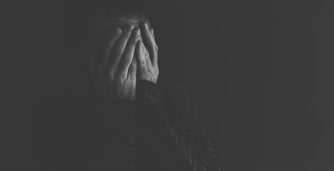 Extremely depressed, crying and distraught male person low key portrait in black and white Extremely depressed, crying and distraught male person low key portrait in black and white