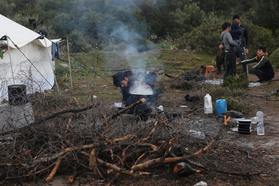 A migrant, who arrived on the island of Lesbos two weeks ago, remains on quarantine with other migrants in open space by Greek authorities, as the country imposed a nationwide lockdown against the spread of the coronavirus disease (COVID-19), near the village of Agios Stefanos, on the island of Lesbos, Greece, April 5, 2020. REUTERS/Elias Marcou A migrant, who arrived on the island of Lesbos two weeks ago, remains on quarantine with other migrants in open space by Greek authorities, as the country imposed a nationwide lockdown against the spread of the coronavirus disease (COVID-19), near the village of Agios Stefanos, on the island of Lesbos, Greece, April 5, 2020. REUTERS/Elias Marcou