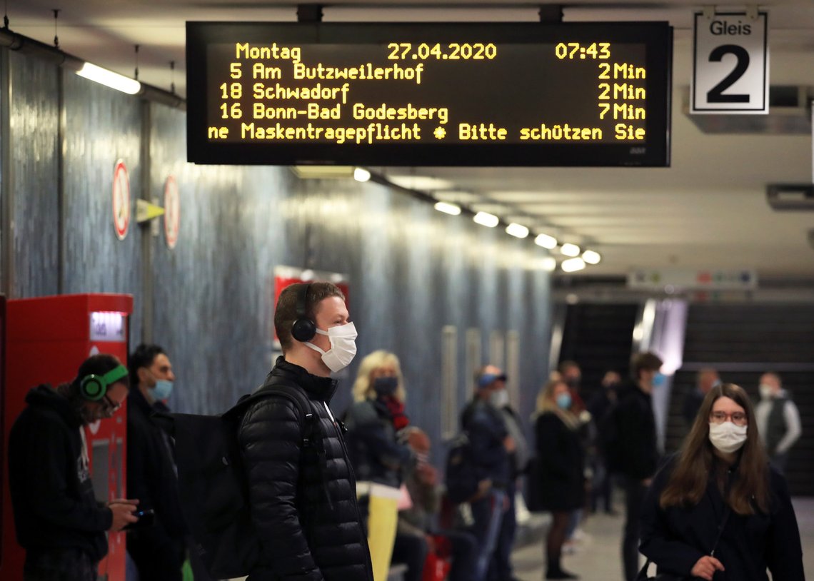 Commuters wearing face masks stand at the Cologne main station after the federal state of North Rhine-Westphalia decided to make wearing protective masks obligatory in buses, trains and shops to fight the spread of the coronavirus disease (COVID-19), in Cologne, Germany, April 27, 2020. REUTERS/Wolfgang Rattay Commuters wearing face masks stand at the Cologne main station after the federal state of North Rhine-Westphalia decided to make wearing protective masks obligatory in buses, trains and shops to fight the spread of the coronavirus disease (COVID-19), in Cologne, Germany, April 27, 2020. REUTERS/Wolfgang Rattay