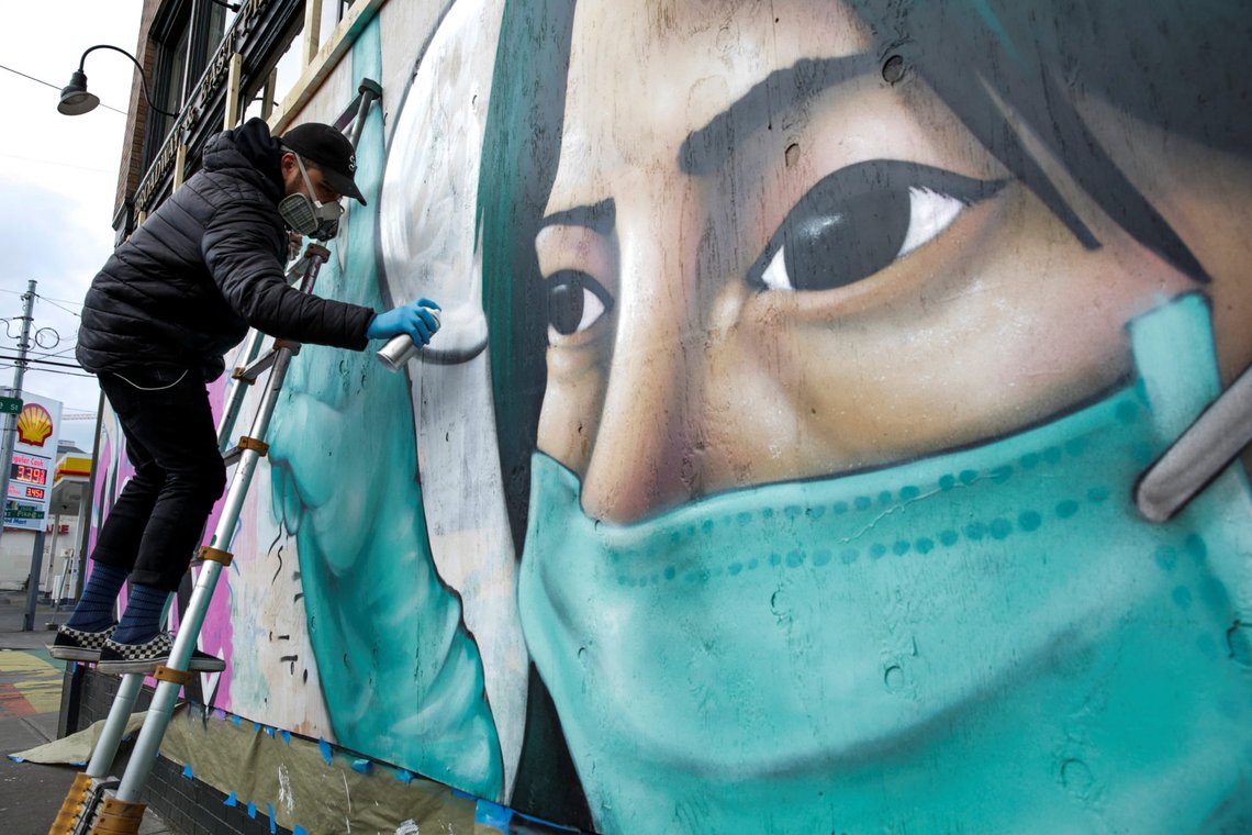 Street artist Carlos Giovanni, who goes by the name TheyDrift, works on the portrait of a healthcare worker for a piece he calls "Stay Home" on the same day that Governor Jay Inslee extended his stay-home order until May 4 as efforts continue to slow the spread of coronavirus disease (COVID-19) in Seattle, Washington, U.S. April 2, 2020. REUTERS/Jason Redmond Street artist Carlos Giovanni, who goes by the name TheyDrift, works on the portrait of a healthcare worker for a piece he calls "Stay Home" on the same day that Governor Jay Inslee extended his stay-home order until May 4 as efforts continue to slow the spread of coronavirus disease (COVID-19) in Seattle, Washington, U.S. April 2, 2020. REUTERS/Jason Redmond
