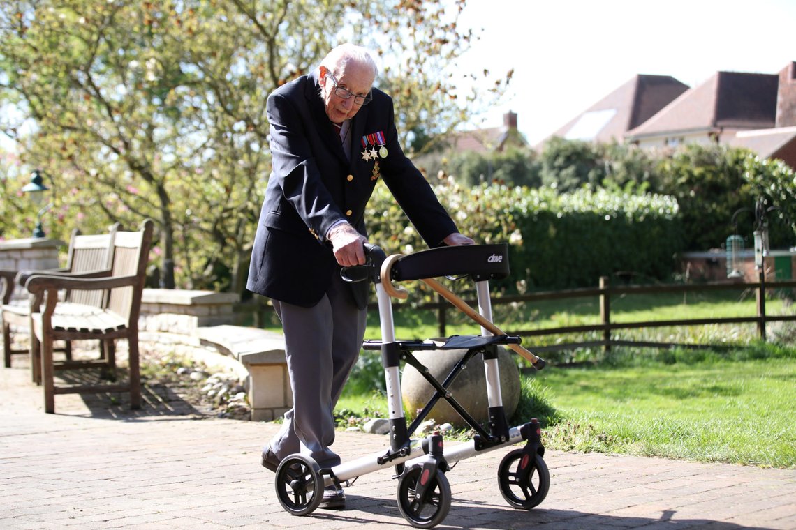 FILE PHOTO: Retired British Army Captain Tom Moore, 99, walks to raise money for health workers, by attempting to walk the length of his garden one hundred times before his 100th birthday this month as the spread of coronavirus disease (COVID-19) continues, Marston Moretaine, Britain, April 15, 2020. REUTERS/Peter Cziborra/File Photo FILE PHOTO: Retired British Army Captain Tom Moore, 99, walks to raise money for health workers, by attempting to walk the length of his garden one hundred times before his 100th birthday this month as the spread of coronavirus disease (COVID-19) continues, Marston Moretaine, Britain, April 15, 2020. REUTERS/Peter Cziborra/File Photo
