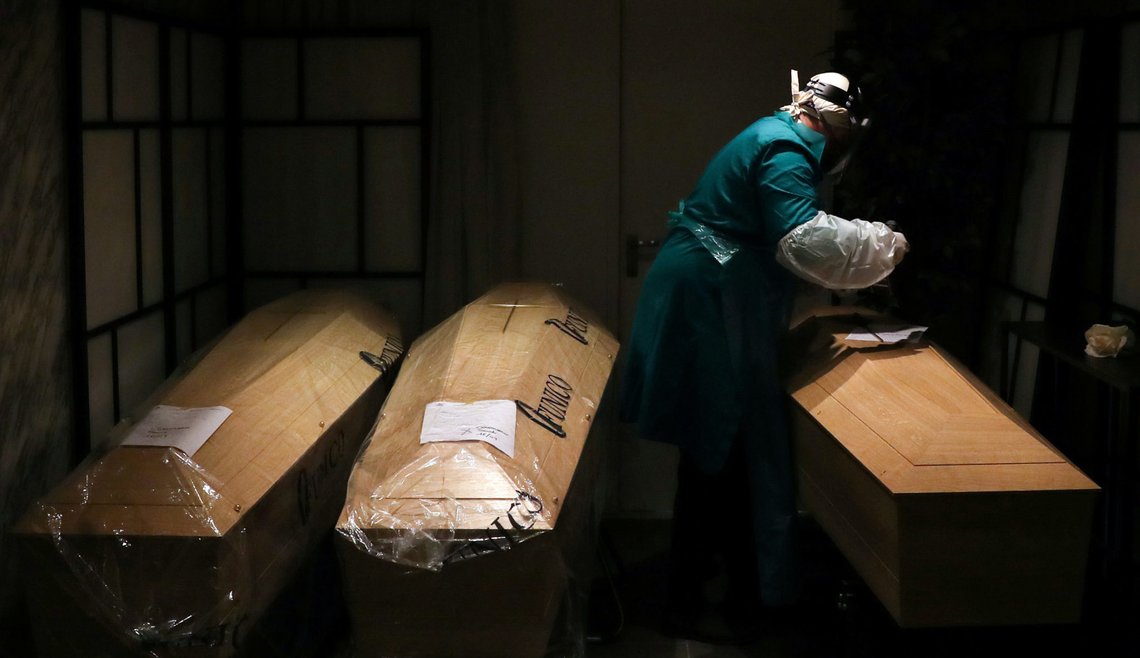 A mortuary worker is pictured amid coffins, during the coronavirus disease (COVID-19) outbreak, in Brussels, Belgium April 9, 2020. REUTERS/Yves Herman TPX IMAGES OF THE DAY A mortuary worker is pictured amid coffins, during the coronavirus disease (COVID-19) outbreak, in Brussels, Belgium April 9, 2020. REUTERS/Yves Herman TPX IMAGES OF THE DAY