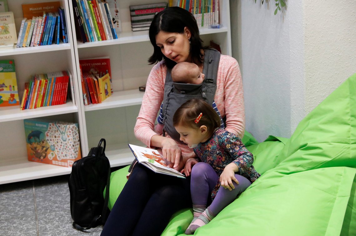 A woman reads a book for her children in a baby-friendly cafe in Budapest, Hungary, January 28, 2020. Picture taken January 28, 2020. REUTERS/Bernadett Szabo A woman reads a book for her children in a baby-friendly cafe in Budapest, Hungary, January 28, 2020. Picture taken January 28, 2020. REUTERS/Bernadett Szabo