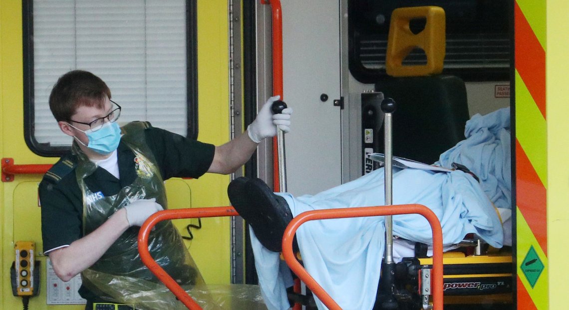Paramedic's with a patient at the back of an ambulance at St Thomas' Hospital as the spread of the coronavirus disease (COVID-19) continues, London, Britain, March 30, 2020. REUTERS/Hannah McKay Paramedic's with a patient at the back of an ambulance at St Thomas' Hospital as the spread of the coronavirus disease (COVID-19) continues, London, Britain, March 30, 2020. REUTERS/Hannah McKay