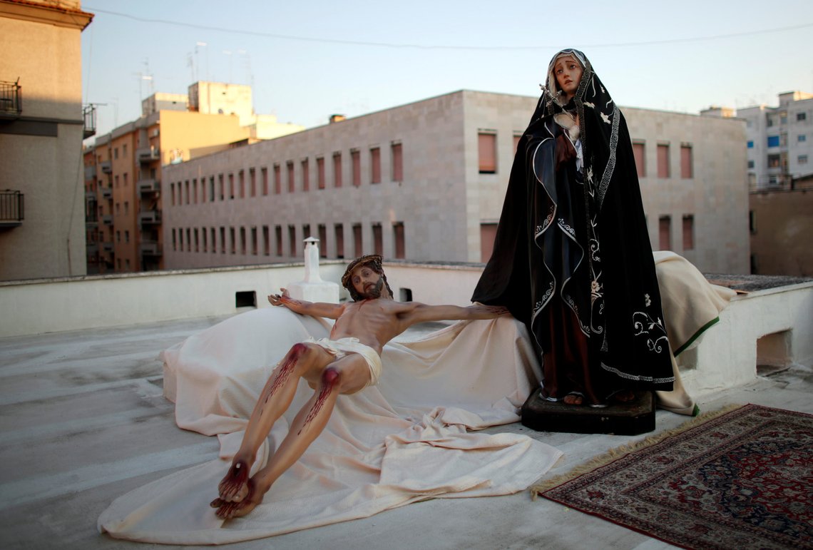 Statues depicting Virgin Mary and Jesus Christ are pictured as priest Don Amedeo Basile leads a Via Crucis (Way of the Cross) procession during Good Friday celebrations on the rooftop of the Maria S.S. Addolorata church for locals to participate from their balconies and windows, as Italy remains on lockdown during the Easter period to try and contain the spread of coronavirus disease (COVID-19), in the southern city of Taranto, Italy, April 10, 2020. REUTERS/Alessandro Garofalo Statues depicting Virgin Mary and Jesus Christ are pictured as priest Don Amedeo Basile leads a Via Crucis (Way of the Cross) procession during Good Friday celebrations on the rooftop of the Maria S.S. Addolorata church for locals to participate from their balconies and windows, as Italy remains on lockdown during the Easter period to try and contain the spread of coronavirus disease (COVID-19), in the southern city of Taranto, Italy, April 10, 2020. REUTERS/Alessandro Garofalo