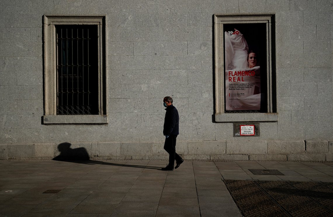 A man walks near the Teatro Real during lockdown, amid the coronavirus disease (COVID-19) outbreak, in Madrid, Spain April 5, 2020. REUTERS/Juan Medina A man walks near the Teatro Real during lockdown, amid the coronavirus disease (COVID-19) outbreak, in Madrid, Spain April 5, 2020. REUTERS/Juan Medina