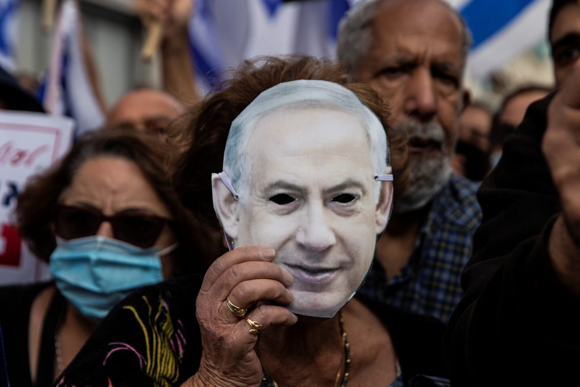 Supporters of Israeli Prime Minister Benjamin Netanyahu wearing protective masks against the coronavirus disease (COVID-19) take part in a protest outside the Prime Minister's Residence, on the day when Netanyahu's corruption trial starts, in Jerusalem May 24, 2020. Heidi levine/Pool via REUTERS Supporters of Israeli Prime Minister Benjamin Netanyahu wearing protective masks against the coronavirus disease (COVID-19) take part in a protest outside the Prime Minister's Residence, on the day when Netanyahu's corruption trial starts, in Jerusalem May 24, 2020. Heidi levine/Pool via REUTERS