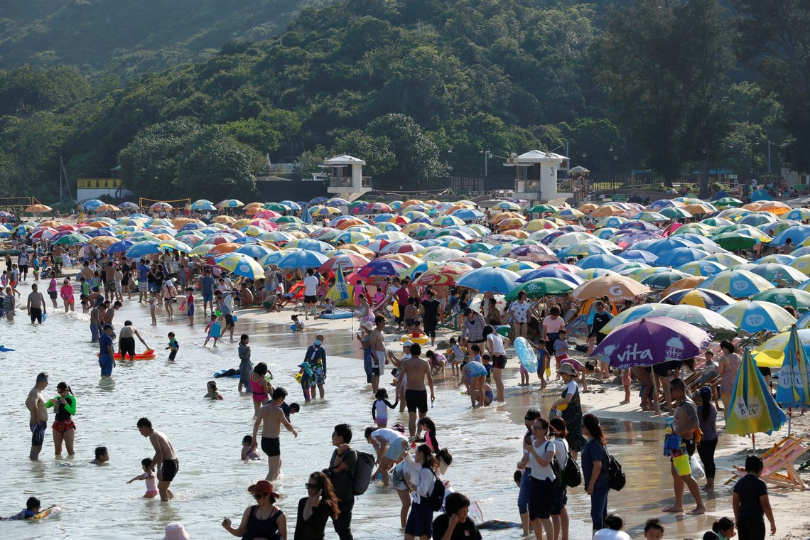 People enjoy the day at a beach after no local coronavirus disease (COVID-19) cases have been recorded for 2 weeks in Hong Kong, China May 3, 2020. REUTERS/Tyrone Siu People enjoy the day at a beach after no local coronavirus disease (COVID-19) cases have been recorded for 2 weeks in Hong Kong, China May 3, 2020. REUTERS/Tyrone Siu