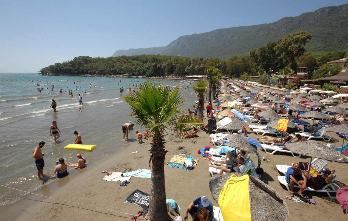 People enjoy the beach and the sea at the Turkish resort of Marmaris as Turkish President Recep Tayyip Erdogan attended a funeral service for the victims of a thwarted coup in Istanbul, Turkey, July 17, 2016. REUTERS/Kenan Gurbuz People enjoy the beach and the sea at the Turkish resort of Marmaris as Turkish President Recep Tayyip Erdogan attended a funeral service for the victims of a thwarted coup in Istanbul, Turkey, July 17, 2016. REUTERS/Kenan Gurbuz