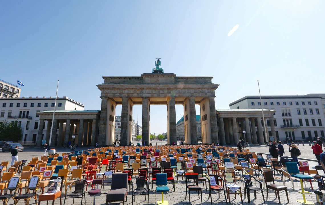 Empty chairs are placed in front of the Brandenburg gate to call attention to the difficult situation of hotel and restaurant owners, as the spread of the coronavirus disease (COVID-19) continues in Berlin, Germany, April 24, 2020. REUTERS/Michele Tantussi Empty chairs are placed in front of the Brandenburg gate to call attention to the difficult situation of hotel and restaurant owners, as the spread of the coronavirus disease (COVID-19) continues in Berlin, Germany, April 24, 2020. REUTERS/Michele Tantussi