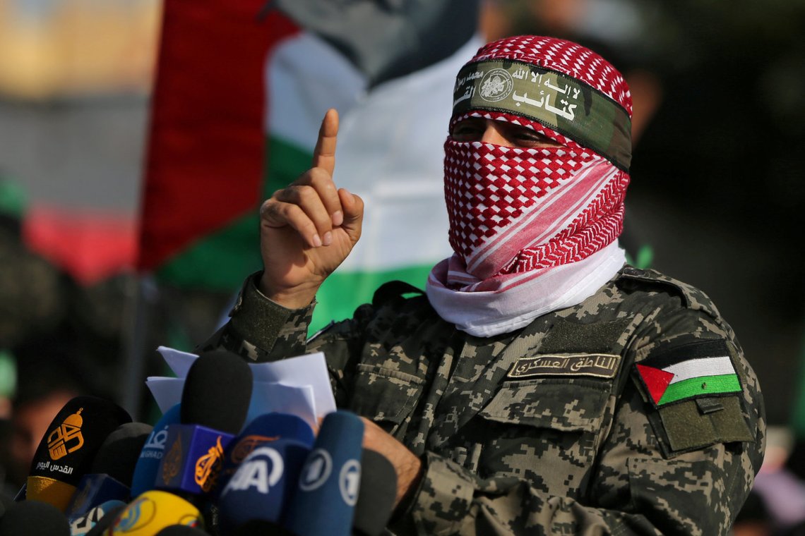 FILE PHOTO: Abu Ubaida, the spokesman of the Izz el-Deen al-Qassam Brigades, gestures as he speaks during an anti-Israel military show in the southern Gaza Strip November 11, 2019. REUTERS/Ibraheem Abu Mustafa/File Photo FILE PHOTO: Abu Ubaida, the spokesman of the Izz el-Deen al-Qassam Brigades, gestures as he speaks during an anti-Israel military show in the southern Gaza Strip November 11, 2019. REUTERS/Ibraheem Abu Mustafa/File Photo