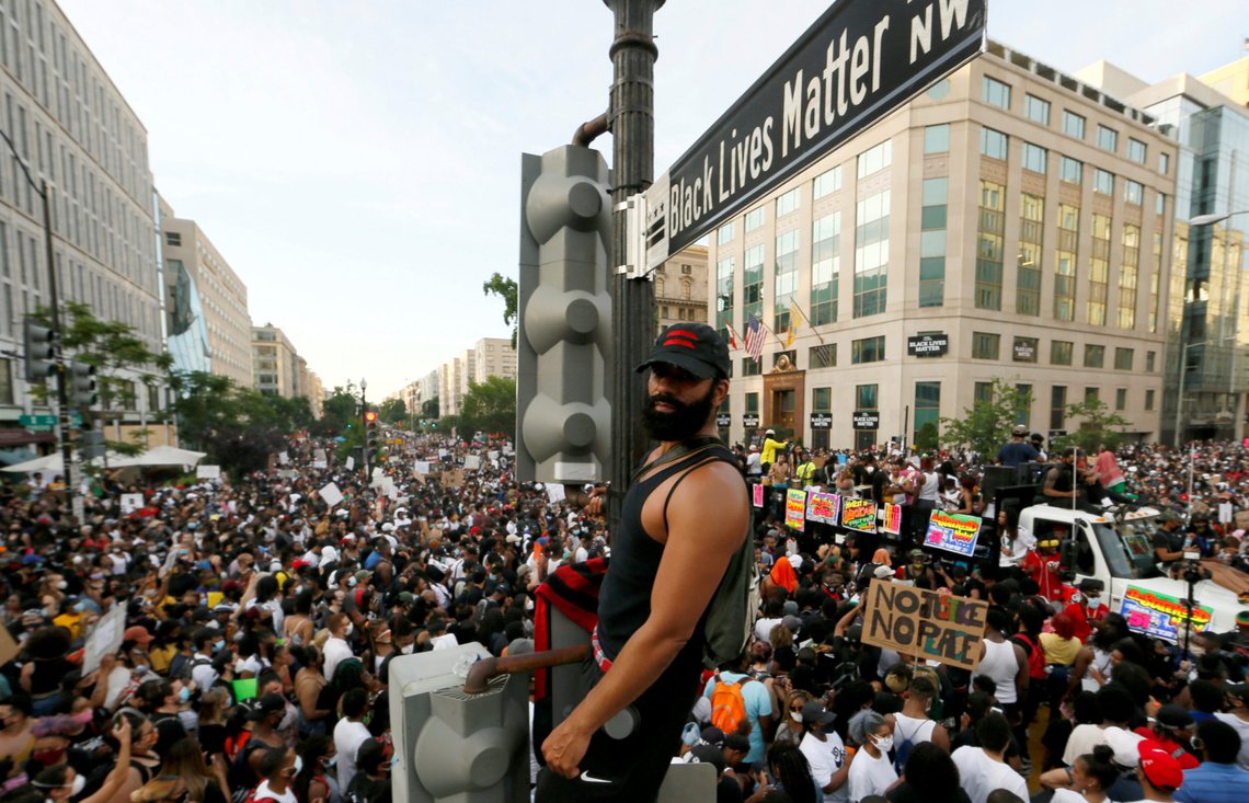 DaSun Millard stands next to Black Lives Matter sign on a traffic light post, at the newly named "Black Lives Matter Plaza" on 16th St., near the White House, during a protest against racial inequality in the aftermath of the death in Minneapolis police custody of George Floyd, in Washington, U.S. June 6, 2020. REUTERS/Jim Bourg TPX IMAGES OF THE DAY DaSun Millard stands next to Black Lives Matter sign on a traffic light post, at the newly named "Black Lives Matter Plaza" on 16th St., near the White House, during a protest against racial inequality in the aftermath of the death in Minneapolis police custody of George Floyd, in Washington, U.S. June 6, 2020. REUTERS/Jim Bourg TPX IMAGES OF THE DAY