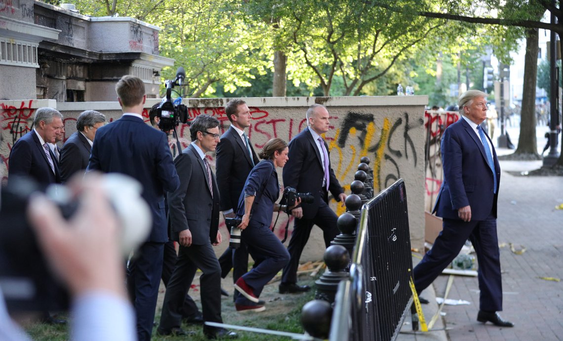 U.S. President Donald Trump is trailed by Secret Service and staff as he walks past a building defaced with graffiti by protestors in Lafayette Park across from the White House while walking back to the White House after a photo opportunity at St John's Church during ongoing protests over racial inequality in the wake of the death of George Floyd while in Minneapolis police custody, at the White House in Washington, U.S., June 1, 2020. REUTERS/Tom Brenner U.S. President Donald Trump is trailed by Secret Service and staff as he walks past a building defaced with graffiti by protestors in Lafayette Park across from the White House while walking back to the White House after a photo opportunity at St John's Church during ongoing protests over racial inequality in the wake of the death of George Floyd while in Minneapolis police custody, at the White House in Washington, U.S., June 1, 2020. REUTERS/Tom Brenner