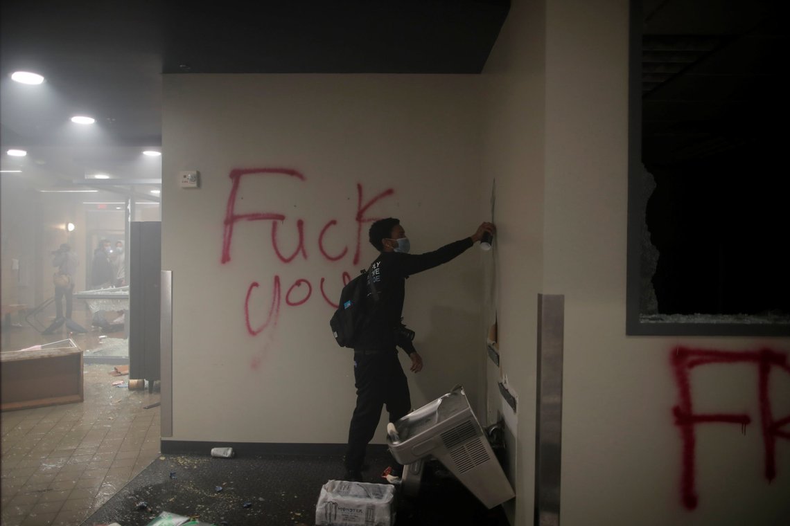 SENSITIVE MATERIAL. THIS IMAGE MAY OFFEND OR DISTURB Protesters are seen inside Minneapolis Police third precinct after setting fire to the entrance as demonstrations continue after a white police officer was caught on a bystander's video pressing his knee into the neck of African-American man George Floyd, who later died at a hospital, in Minneapolis, Minnesota, U.S., May 29, 2020. REUTERS/Carlos Barria SENSITIVE MATERIAL. THIS IMAGE MAY OFFEND OR DISTURB Protesters are seen inside Minneapolis Police third precinct after setting fire to the entrance as demonstrations continue after a white police officer was caught on a bystander's video pressing his knee into the neck of African-American man George Floyd, who later died at a hospital, in Minneapolis, Minnesota, U.S., May 29, 2020. REUTERS/Carlos Barria