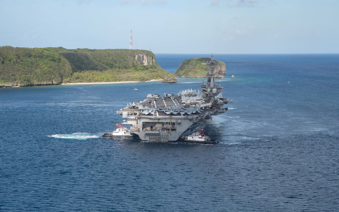 The U.S. Navy aircraft carrier USS Theodore Roosevelt departs following an extended visit in the midst of a coronavirus disease (COVID-19) outbreak, from Apra Harbor, Guam May 21, 2020. Picture taken May 21, 2020. U.S. Navy/Mass Communication Specialist Seaman Kaylianna Genier/Handout via REUTERS. THIS IMAGE HAS BEEN SUPPLIED BY A THIRD PARTY. The U.S. Navy aircraft carrier USS Theodore Roosevelt departs following an extended visit in the midst of a coronavirus disease (COVID-19) outbreak, from Apra Harbor, Guam May 21, 2020. Picture taken May 21, 2020. U.S. Navy/Mass Communication Specialist Seaman Kaylianna Genier/Handout via REUTERS. THIS IMAGE HAS BEEN SUPPLIED BY A THIRD PARTY.