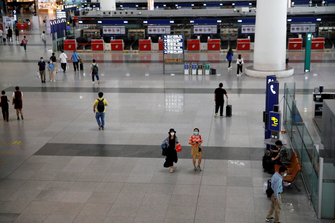People are seen at the departure hall of Beijing Capital International Airport after scores of domestic flights in and out of the Chinese capital were cancelled following the new outbreak of the coronavirus disease (COVID-19) in Beijing, China June 17, 2020. REUTERS/Carlos Garcia Rawlins People are seen at the departure hall of Beijing Capital International Airport after scores of domestic flights in and out of the Chinese capital were cancelled following the new outbreak of the coronavirus disease (COVID-19) in Beijing, China June 17, 2020. REUTERS/Carlos Garcia Rawlins