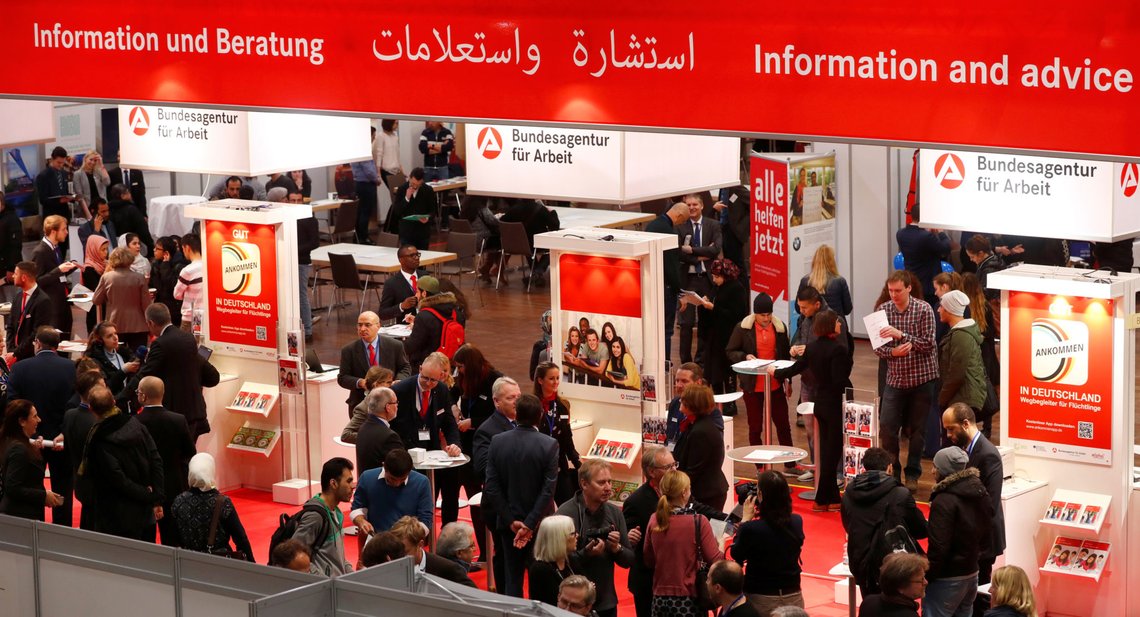 FILE PHOTO: People visit the second job fair for migrants and refugees in Berlin, Germany, January 25, 2017. To match Insight EUROPE-MIGRANTS/GERMANY-SYRIANS REUTERS/Fabrizio Bensch/File Photo FILE PHOTO: People visit the second job fair for migrants and refugees in Berlin, Germany, January 25, 2017. To match Insight EUROPE-MIGRANTS/GERMANY-SYRIANS REUTERS/Fabrizio Bensch/File Photo
