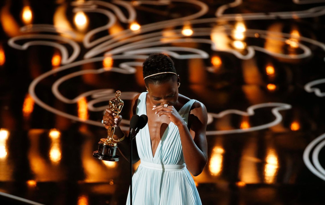 Lupita Nyong'o, best supporting actress winner for her role in "12 Years a Slave", reacts on stage at the 86th Academy Awards in Hollywood, California March 2, 2014. REUTERS/Lucy Nicholson (UNITED STATES TAGS: ENTERTAINMENT) (OSCARS-SHOW) Lupita Nyong'o, best supporting actress winner for her role in "12 Years a Slave", reacts on stage at the 86th Academy Awards in Hollywood, California March 2, 2014. REUTERS/Lucy Nicholson (UNITED STATES TAGS: ENTERTAINMENT) (OSCARS-SHOW)