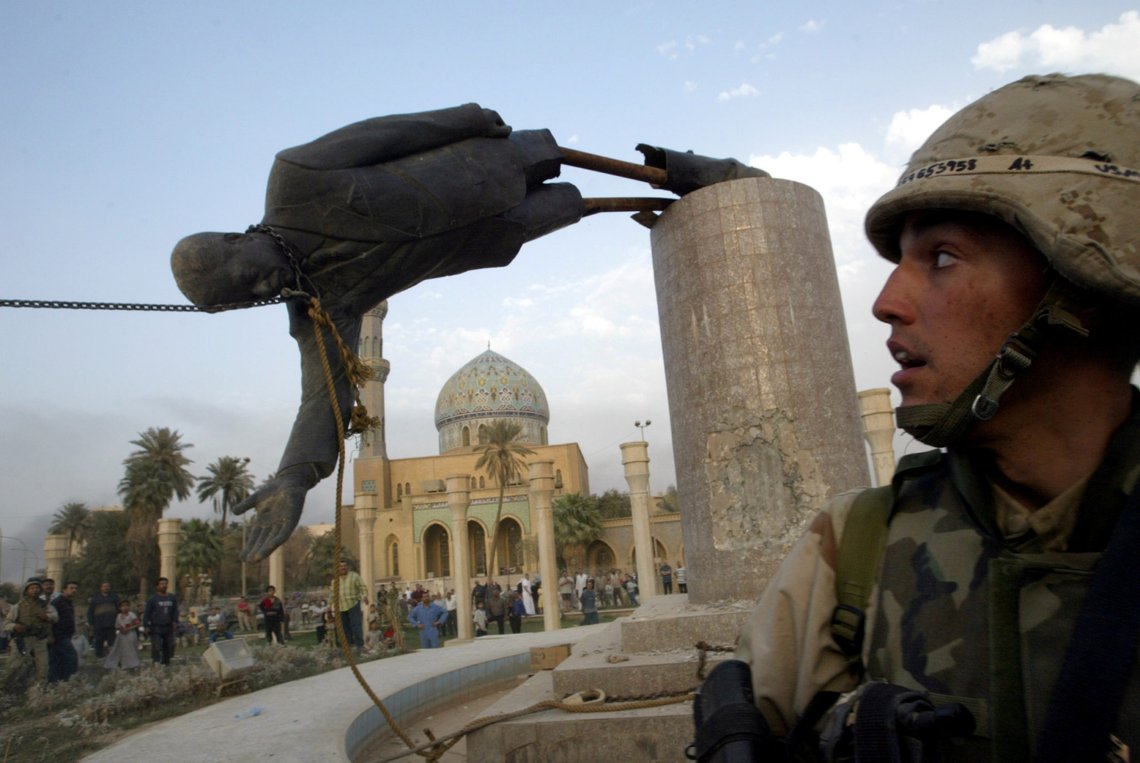 FILE PHOTO: A U.S. soldier watches as a statue of Iraq's President Saddam Hussein falls in central Baghdad, Iraq April 9, 2003. REUTERS/Goran Tomasevic/File Photo FILE PHOTO: A U.S. soldier watches as a statue of Iraq's President Saddam Hussein falls in central Baghdad, Iraq April 9, 2003. REUTERS/Goran Tomasevic/File Photo