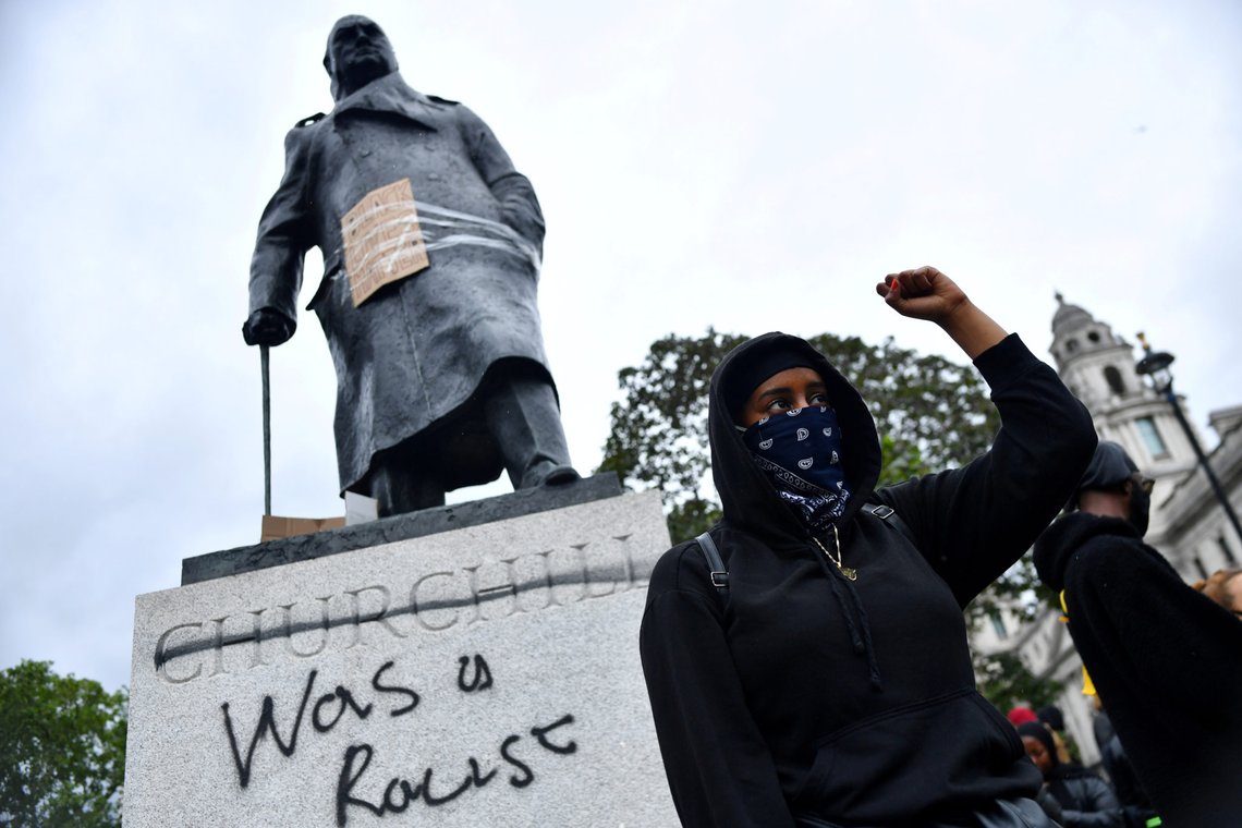 FILE PHOTO: A demonstrator reacts infront of graffiti on a statue of Winston Churchill in Parliament Square during a Black Lives Matter protest in London, following the death of George Floyd who died in police custody in Minneapolis, London, Britain, June 7, 2020. REUTERS/Dylan Martinez TPX IMAGES OF THE DAY - RC2G4H9061BN/File Photo FILE PHOTO: A demonstrator reacts infront of graffiti on a statue of Winston Churchill in Parliament Square during a Black Lives Matter protest in London, following the death of George Floyd who died in police custody in Minneapolis, London, Britain, June 7, 2020. REUTERS/Dylan Martinez TPX IMAGES OF THE DAY - RC2G4H9061BN/File Photo