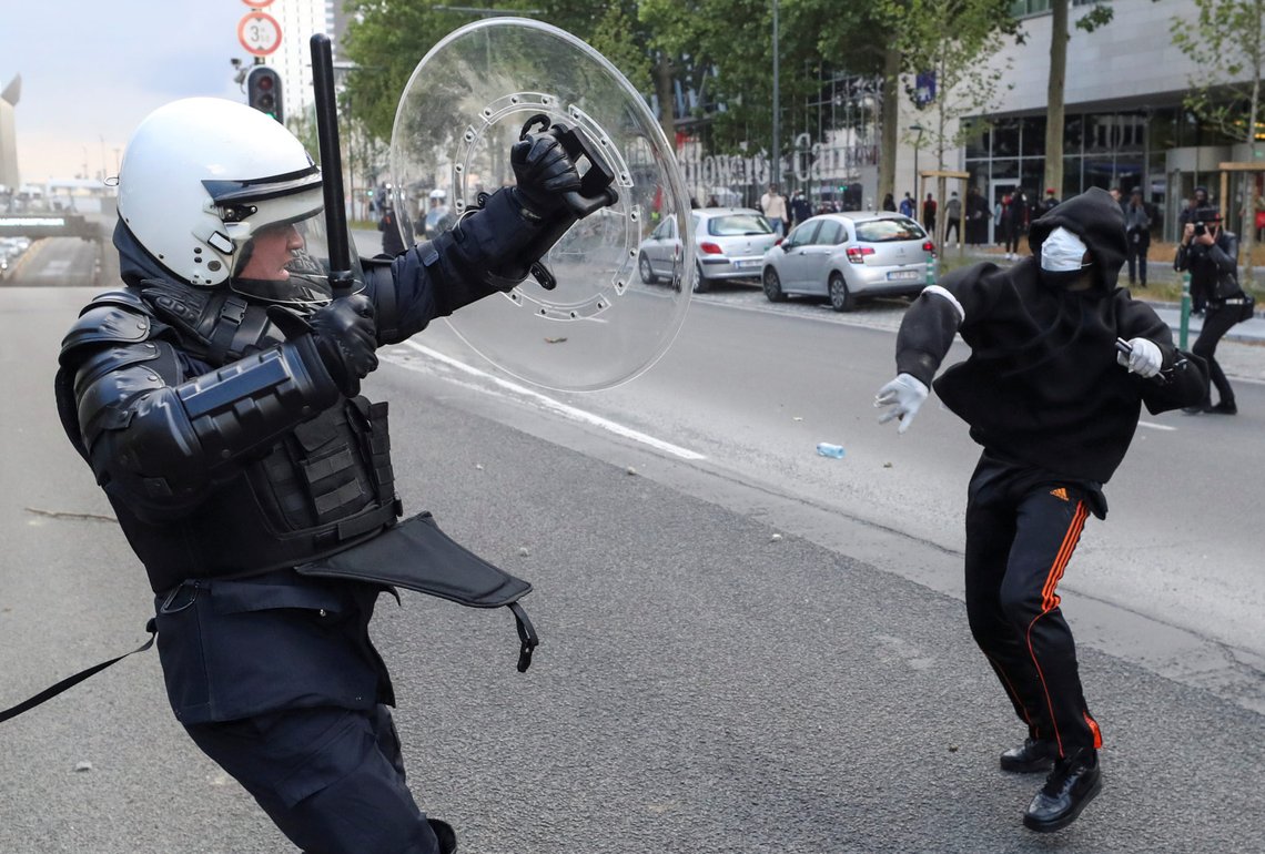 A demonstrator throws an object towards a police officer during a protest, organised by Black Lives Matter Belgium, against racial inequality in the aftermath of the death in Minneapolis police custody of George Floyd, in central Brussels, Belgium June 7, 2020. REUTERS/Yves Herman TPX IMAGES OF THE DAY A demonstrator throws an object towards a police officer during a protest, organised by Black Lives Matter Belgium, against racial inequality in the aftermath of the death in Minneapolis police custody of George Floyd, in central Brussels, Belgium June 7, 2020. REUTERS/Yves Herman TPX IMAGES OF THE DAY