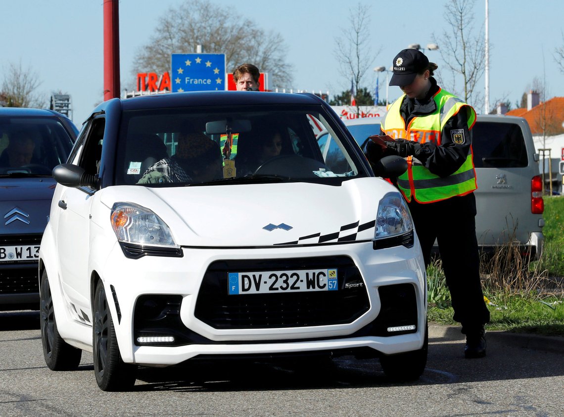 FILE PHOTO: A German police officer checks a car at the border with France due to the spreading of the coronavirus disease (COVID-19) in Saarbruecken, Germany, March 16, 2020. REUTERS/Ralph Orlowski/File Photo FILE PHOTO: A German police officer checks a car at the border with France due to the spreading of the coronavirus disease (COVID-19) in Saarbruecken, Germany, March 16, 2020. REUTERS/Ralph Orlowski/File Photo