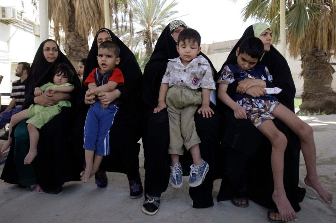 Residents wait to receive wheelchairs distributed by U.S. and Iraqi security forces for needy children at al-Fadhil clinic in Baghdad April 14, 2009. REUTERS/Atef Hassan (IRAQ) Residents wait to receive wheelchairs distributed by U.S. and Iraqi security forces for needy children at al-Fadhil clinic in Baghdad April 14, 2009. REUTERS/Atef Hassan (IRAQ)