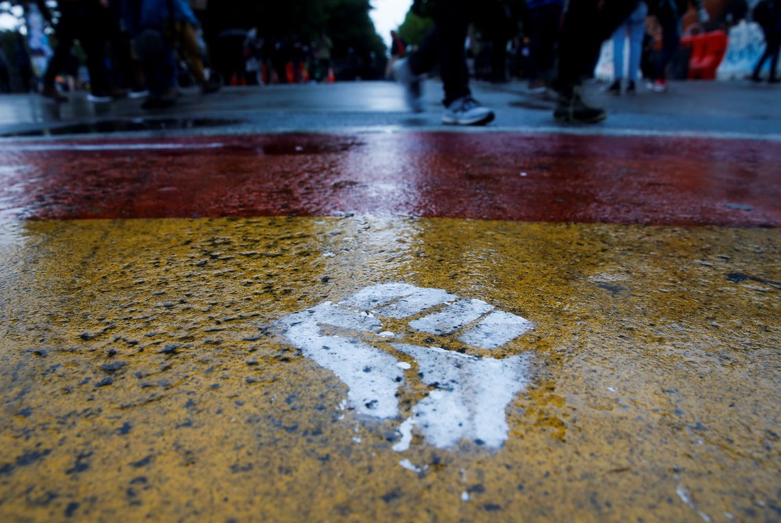A raised fist is painted into one of the neighbourhood's rainbow crosswalks as the protesters established what they call an autonomous zone while continuing to demonstrate against racial inequality and call for defunding of Seattle police, in Seattle, Washington, U.S. June 9, 2020. Picture taken June 9, 2020. REUTERS/Lindsey Wasson A raised fist is painted into one of the neighbourhood's rainbow crosswalks as the protesters established what they call an autonomous zone while continuing to demonstrate against racial inequality and call for defunding of Seattle police, in Seattle, Washington, U.S. June 9, 2020. Picture taken June 9, 2020. REUTERS/Lindsey Wasson