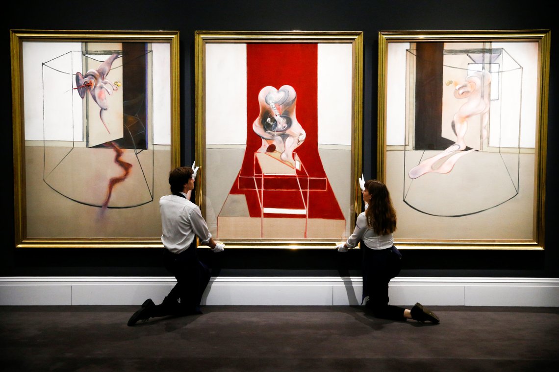Gallery assistants pose for photographers during the photocall for 'Triptych Inspired by the Oresteia of Aeschylus' by British painter Francis Bacon, with an estimate in excess of $60 million when it goes to auction in New York on May 13th 2020, at Sotheby's auction house in London, Britain, March 6 2020. REUTERS/Henry Nicholls Gallery assistants pose for photographers during the photocall for 'Triptych Inspired by the Oresteia of Aeschylus' by British painter Francis Bacon, with an estimate in excess of $60 million when it goes to auction in New York on May 13th 2020, at Sotheby's auction house in London, Britain, March 6 2020. REUTERS/Henry Nicholls